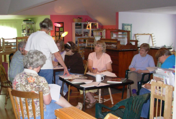 Women listening to weaving lecture